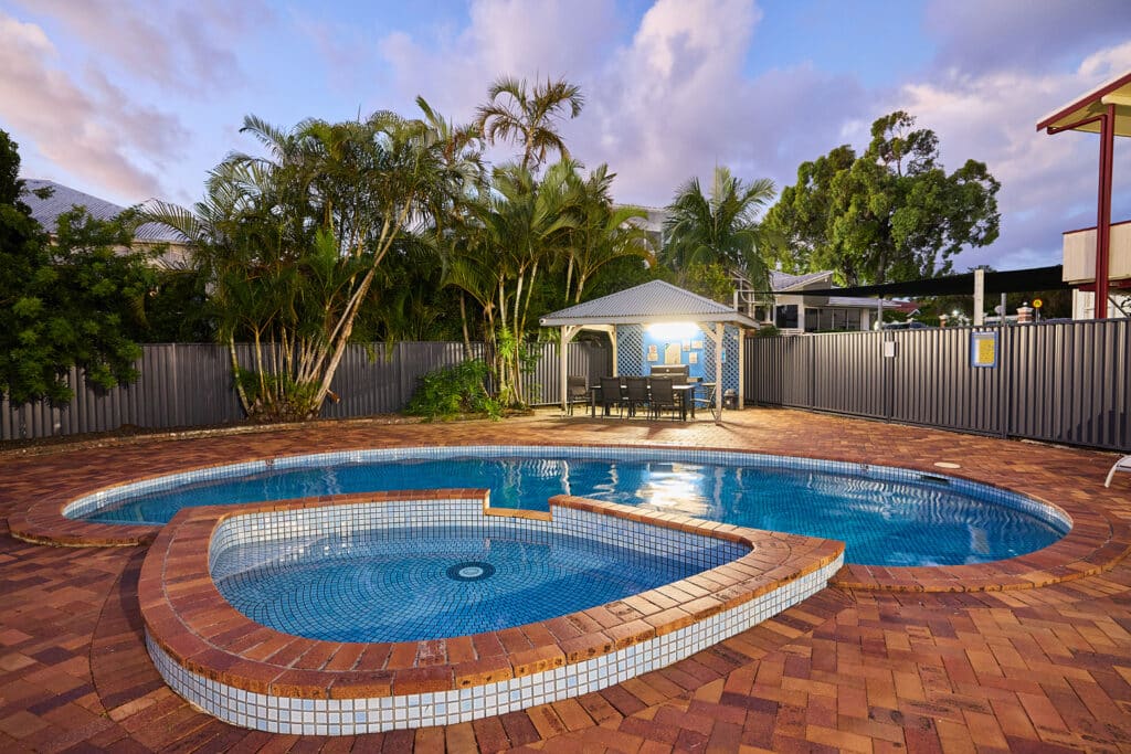 Pool, spa and BBQ area at dusk