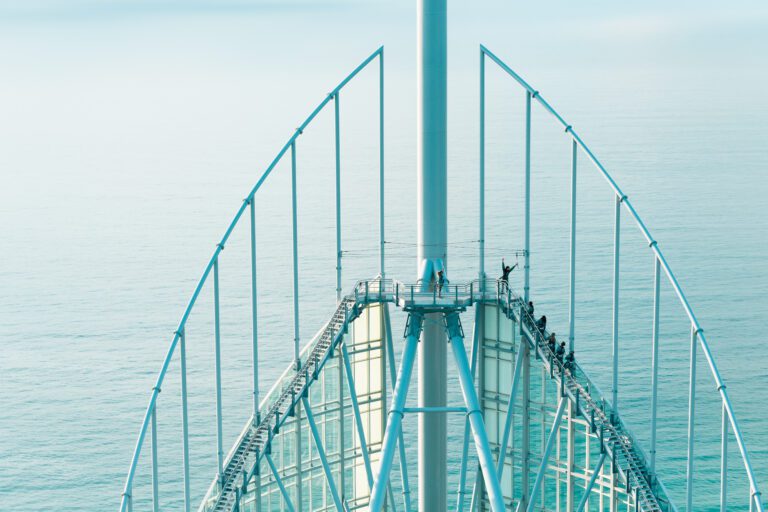 Peak of SkyPoint tower with ocean in background