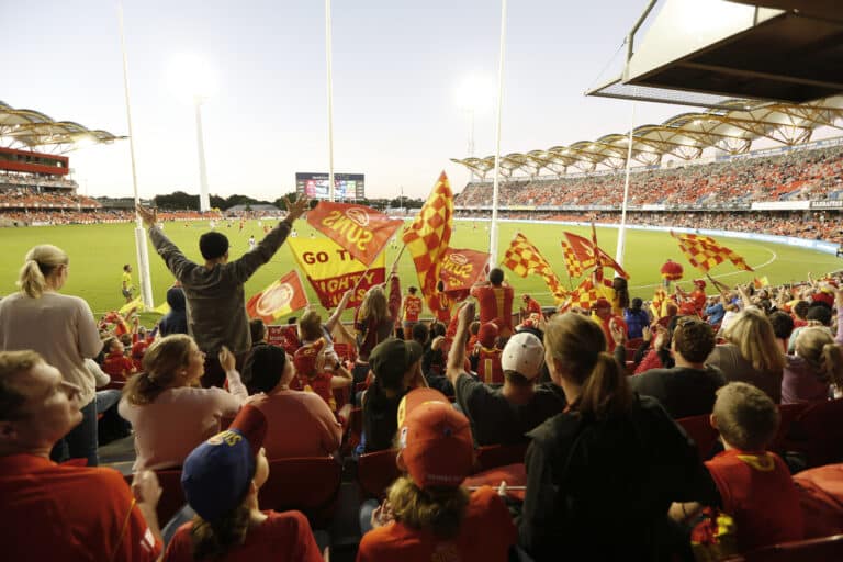 Gold Coast Suns fans experiencing the thrill of watching the game in a stadium