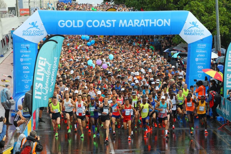 Runners starting out on the Gold Coast Marathon under banner.