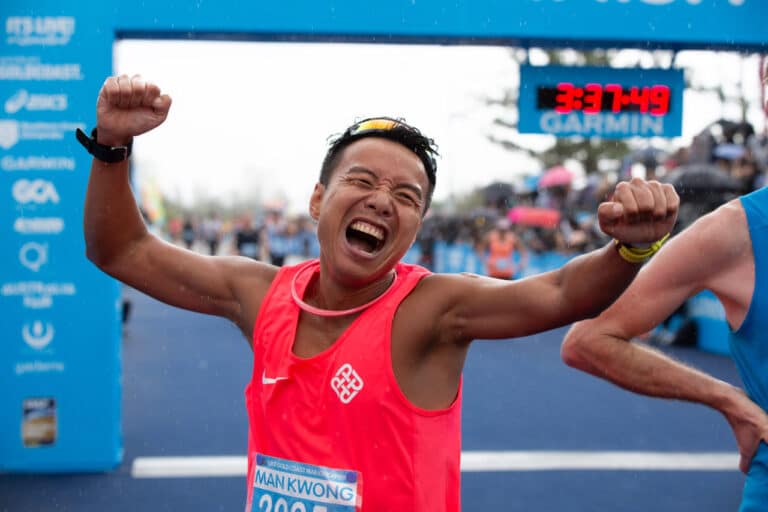 Man crossing finish line of marathon