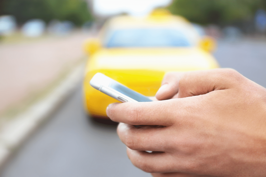Hand and phone ordering a ride share service