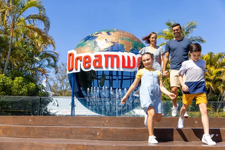 Family walking down stairs with Dreamworld sign behind them